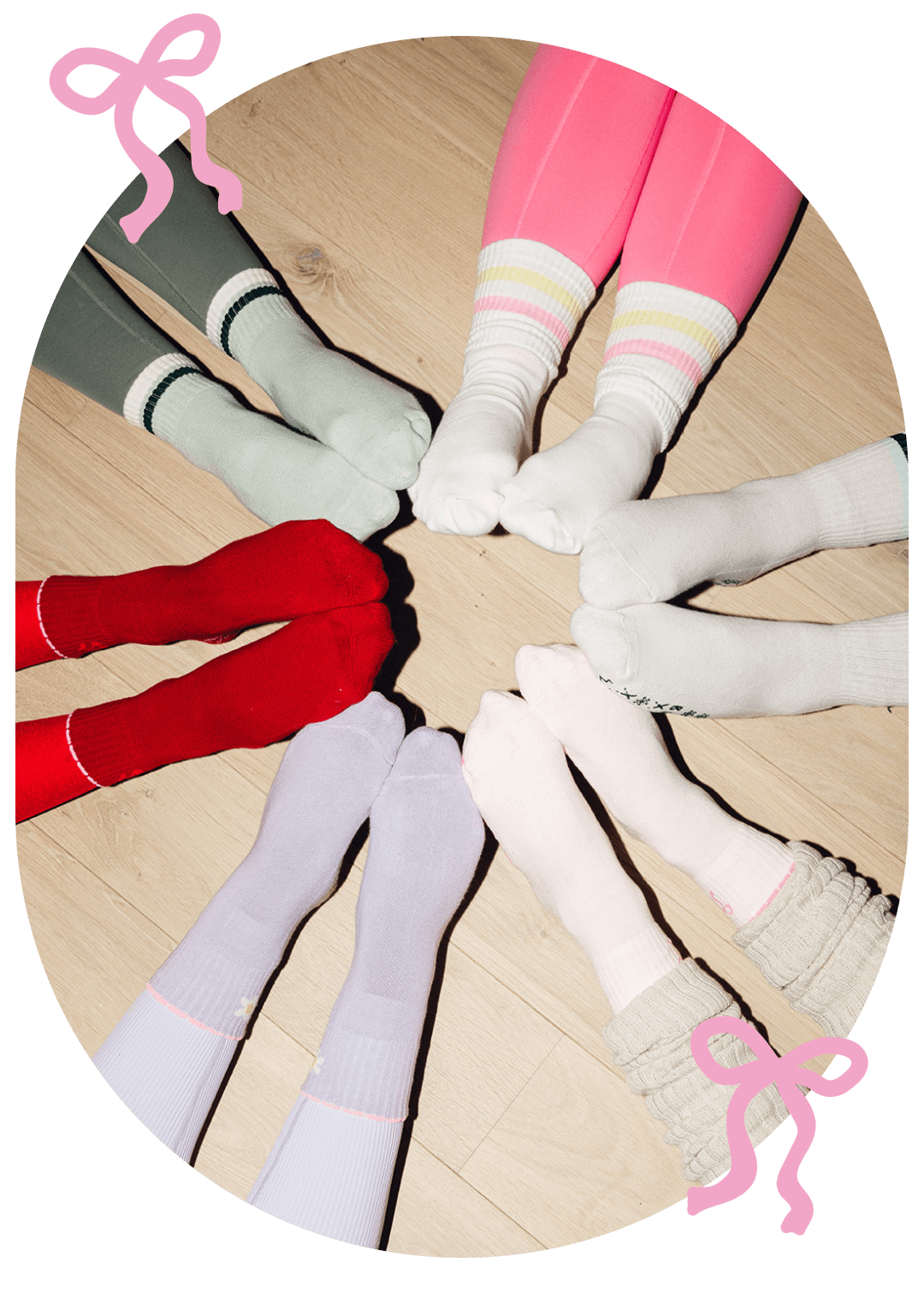 6 pairs of different colored, fun Pilates socks on girls making a circle while pointing their toes.